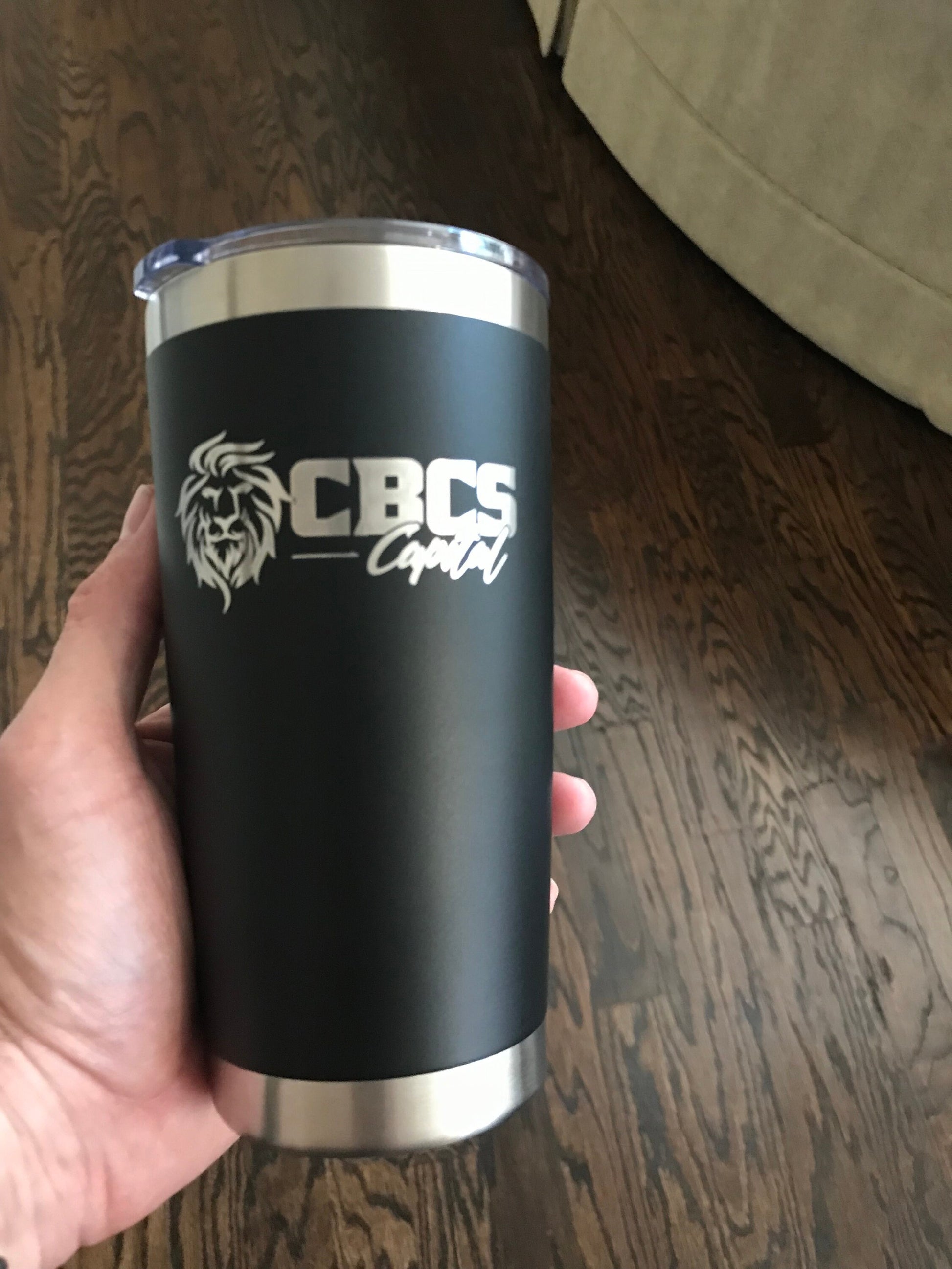 Laser Engraved 20 Ounce Stainless Steel Tumbler Held in Hand