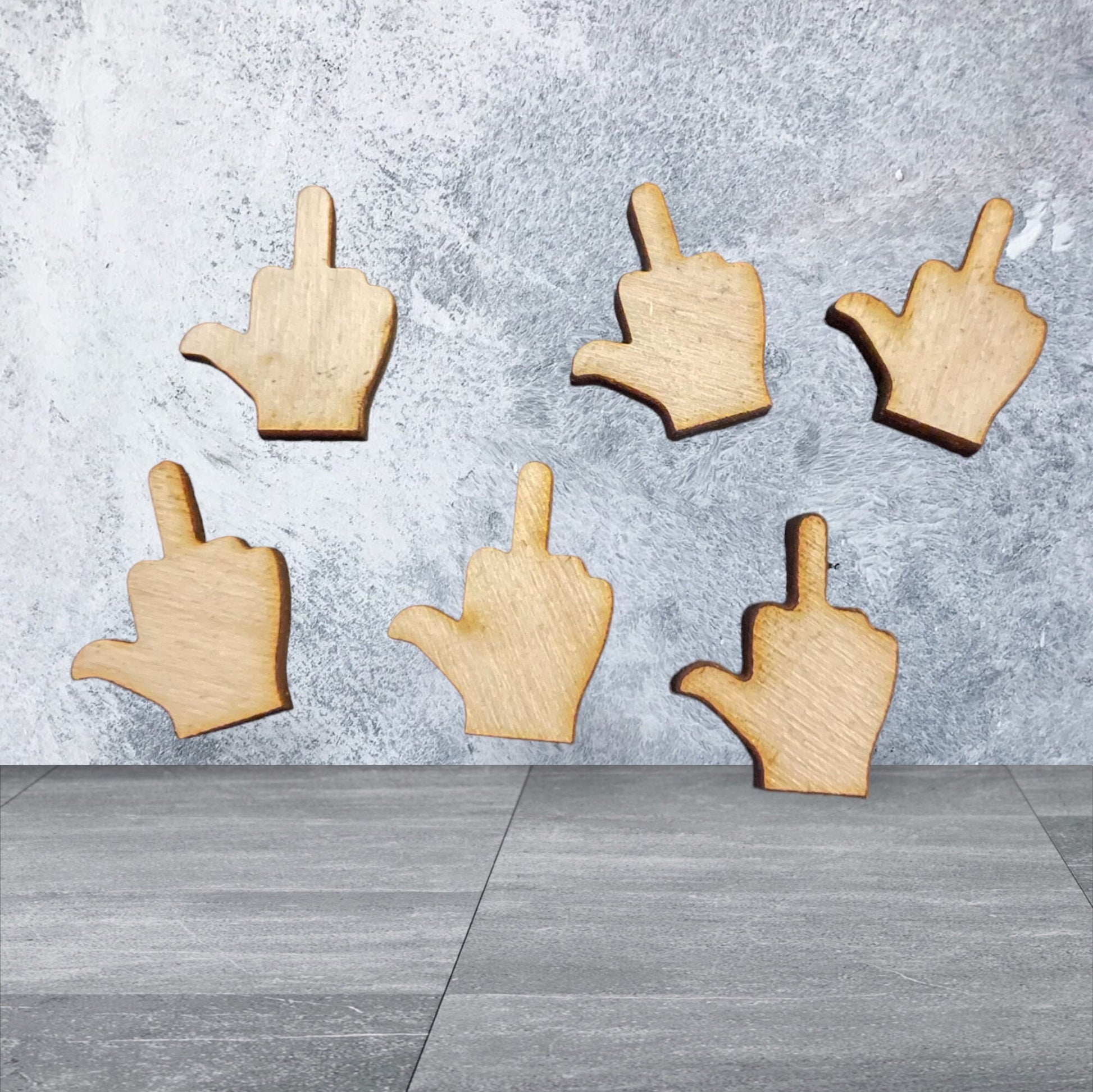 Laser Cut middle fingers on soft background